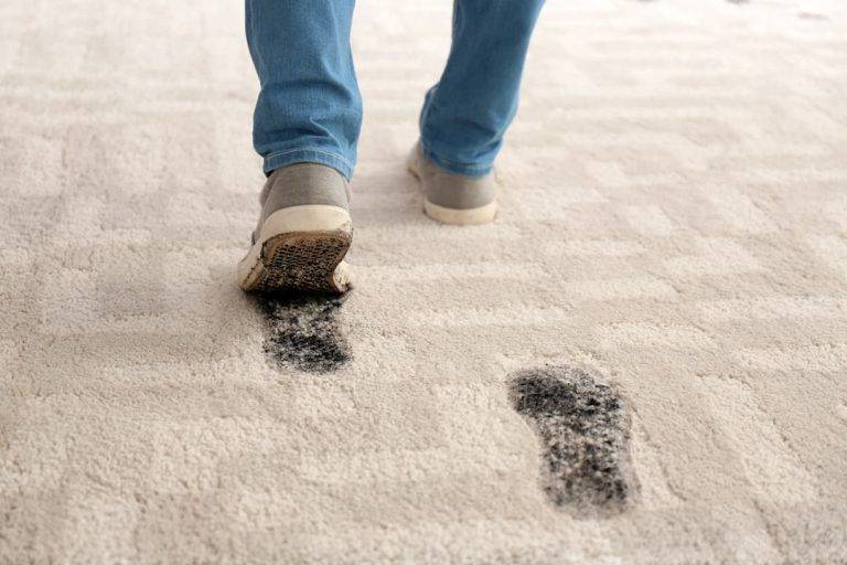 shoes leaving muddy footprints on carpet